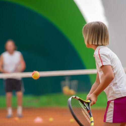 Young Child Playing Tennis