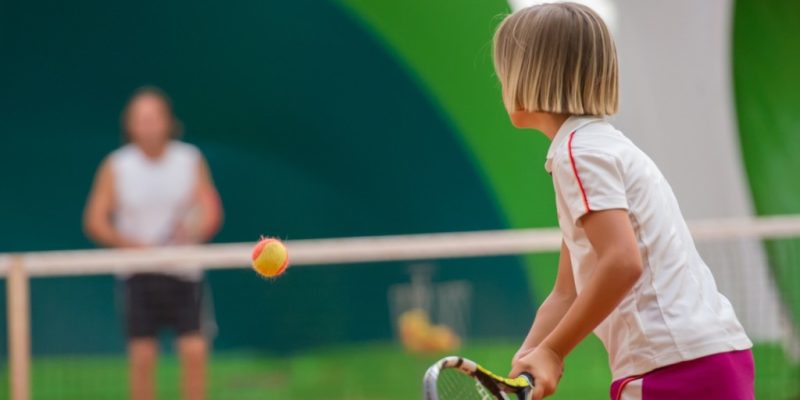 Young Child Playing Tennis