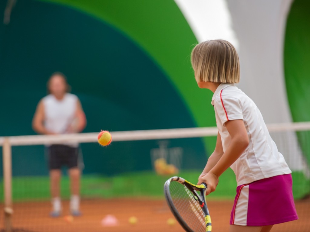 Young Child Playing Tennis