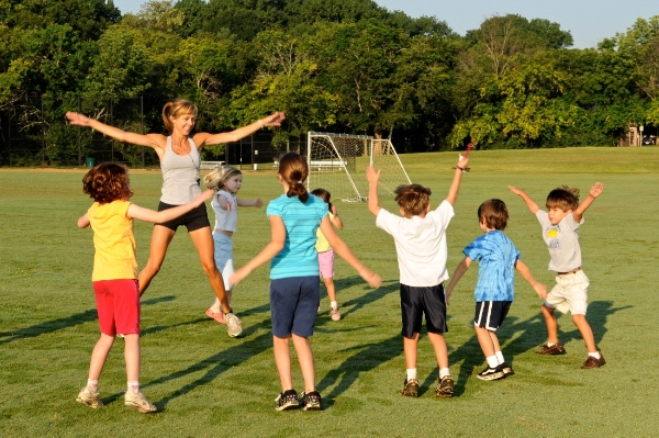 Instructor and children doing high-intensity interval training