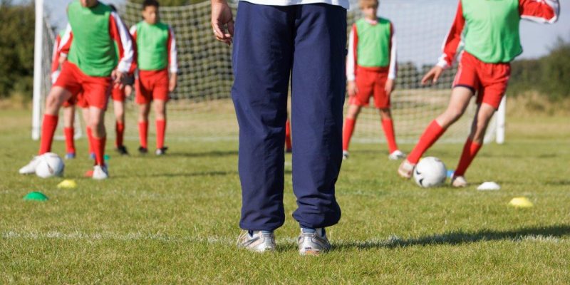 coach doing motivational drills with their team