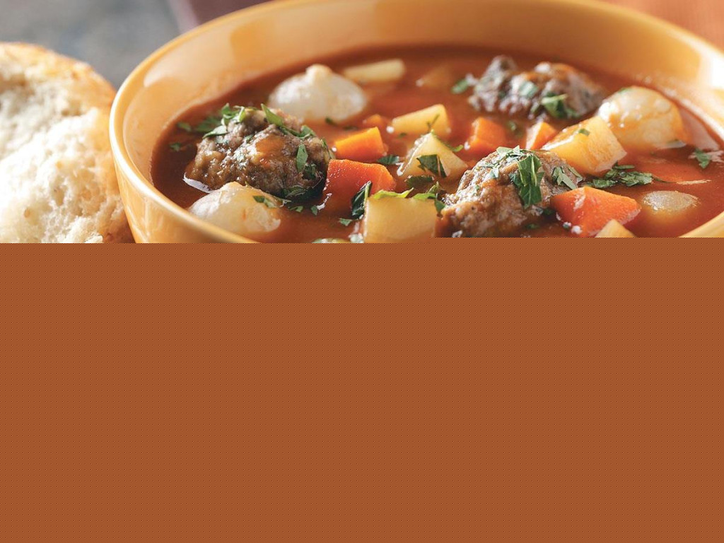 Bowl of meatball stew with biscuits