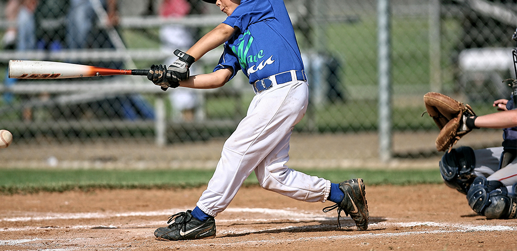 boy playing baseball in dirty black shoes