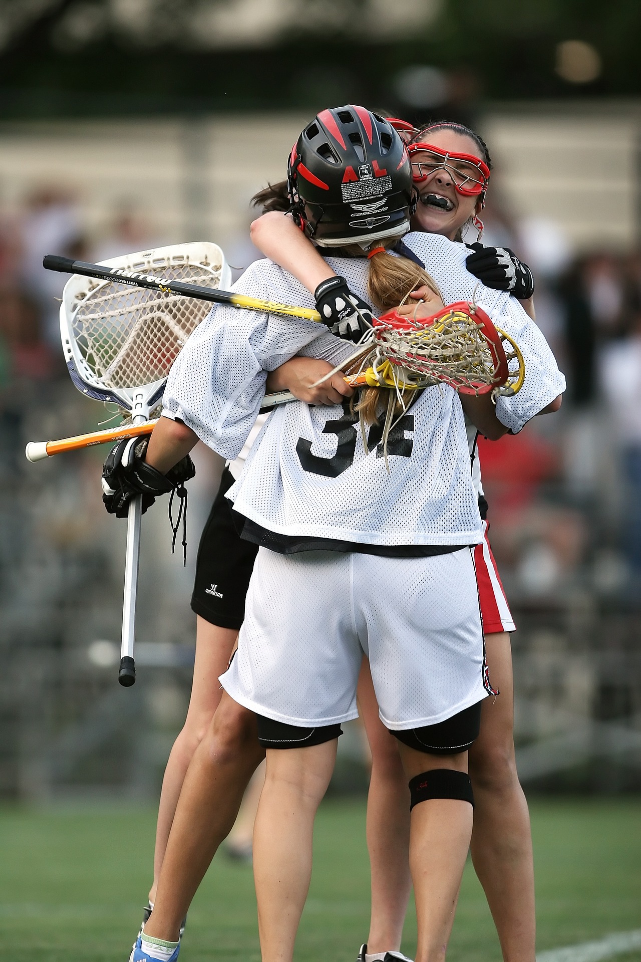Girl Lacrosse Players celebrate on the field