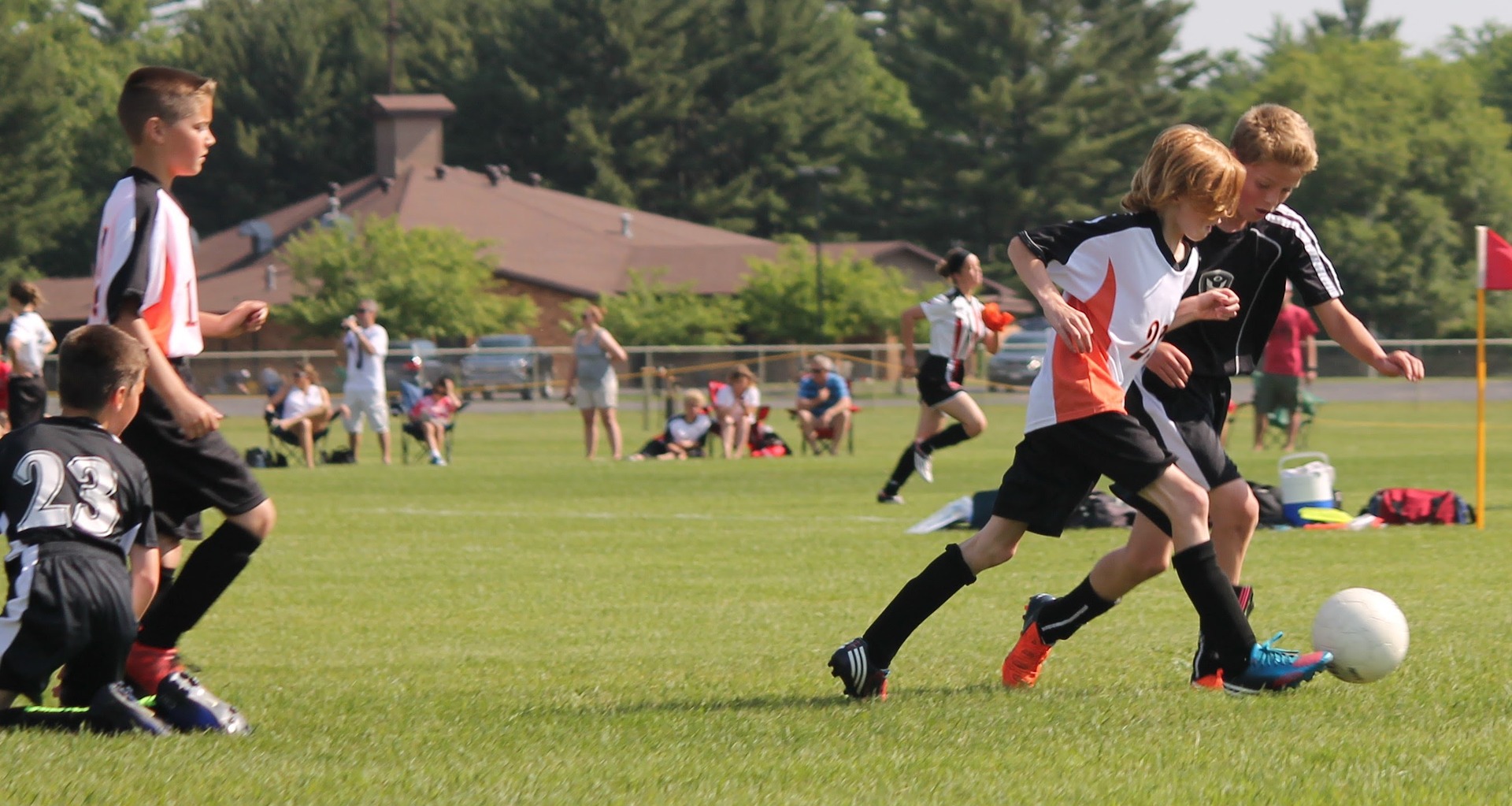 kids playing soccer on field