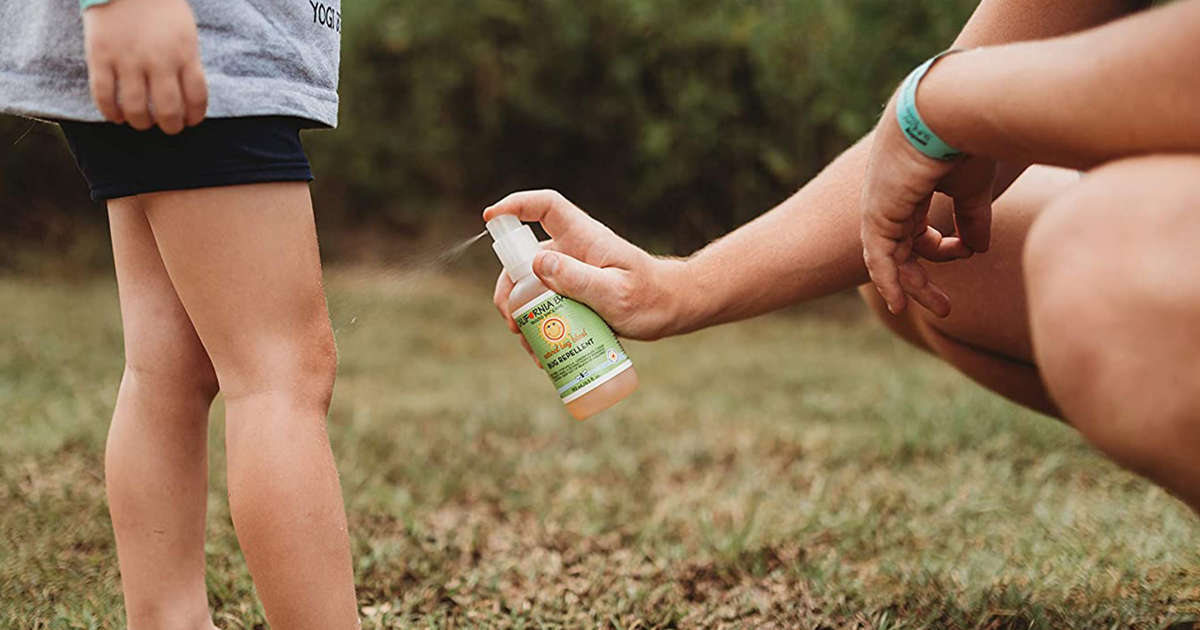 Bug spray being sprayed on a child's knee
