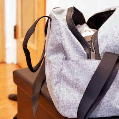 A view of a grey sports bag on a bench in a room