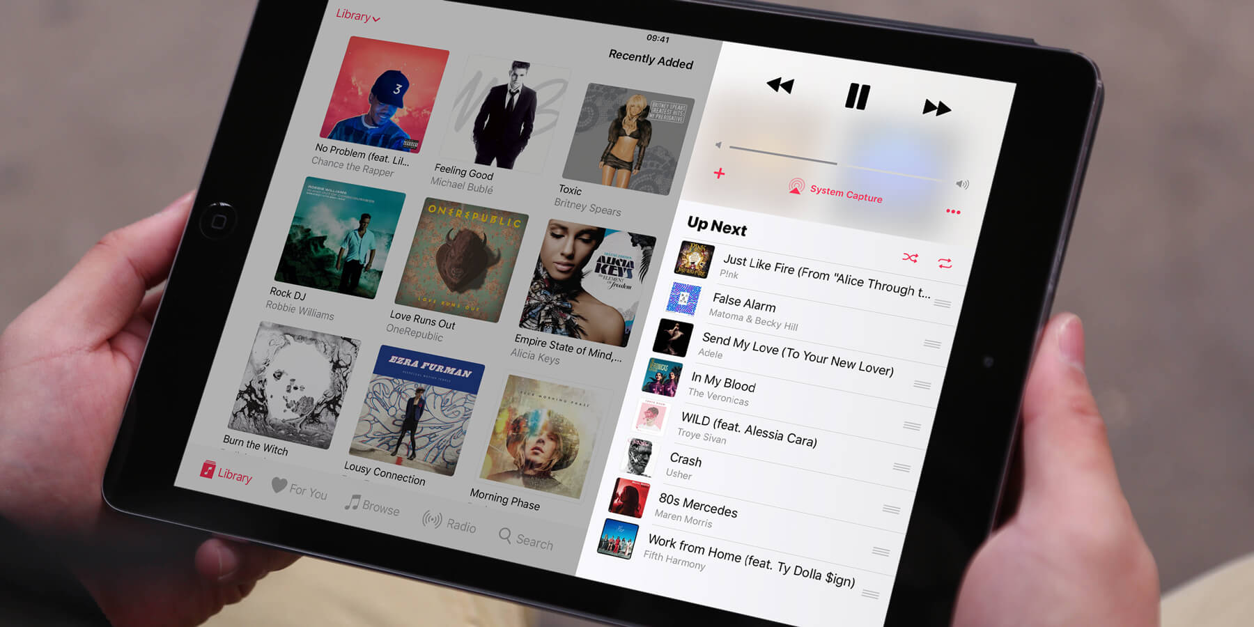 Close-up of tablet screen showing music streaming app