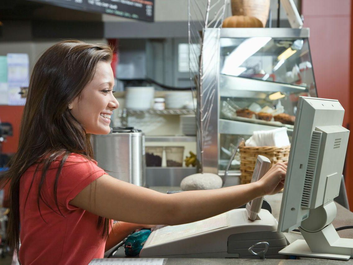 Smiling teenager working at concession stand for athletic event