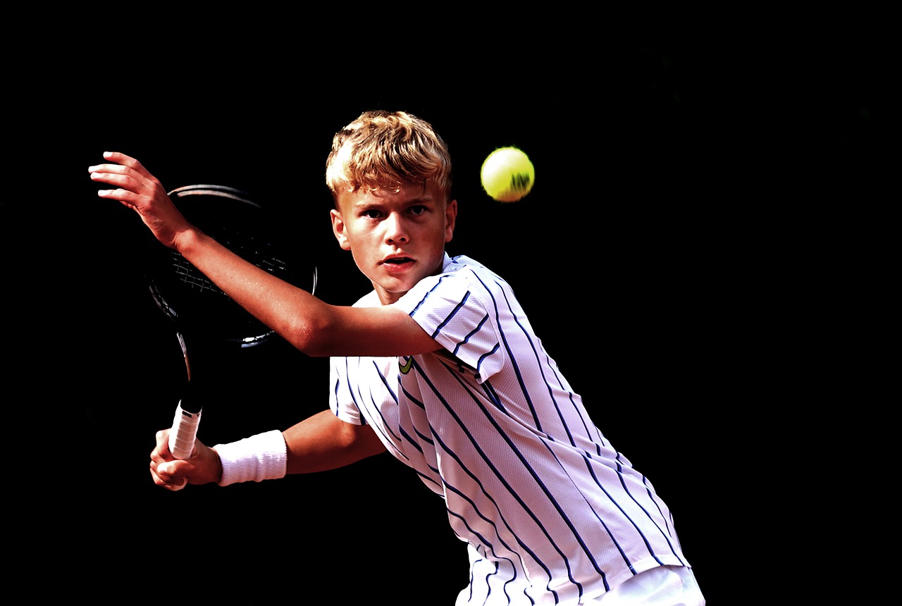 Young tennis player about to strike ball during match