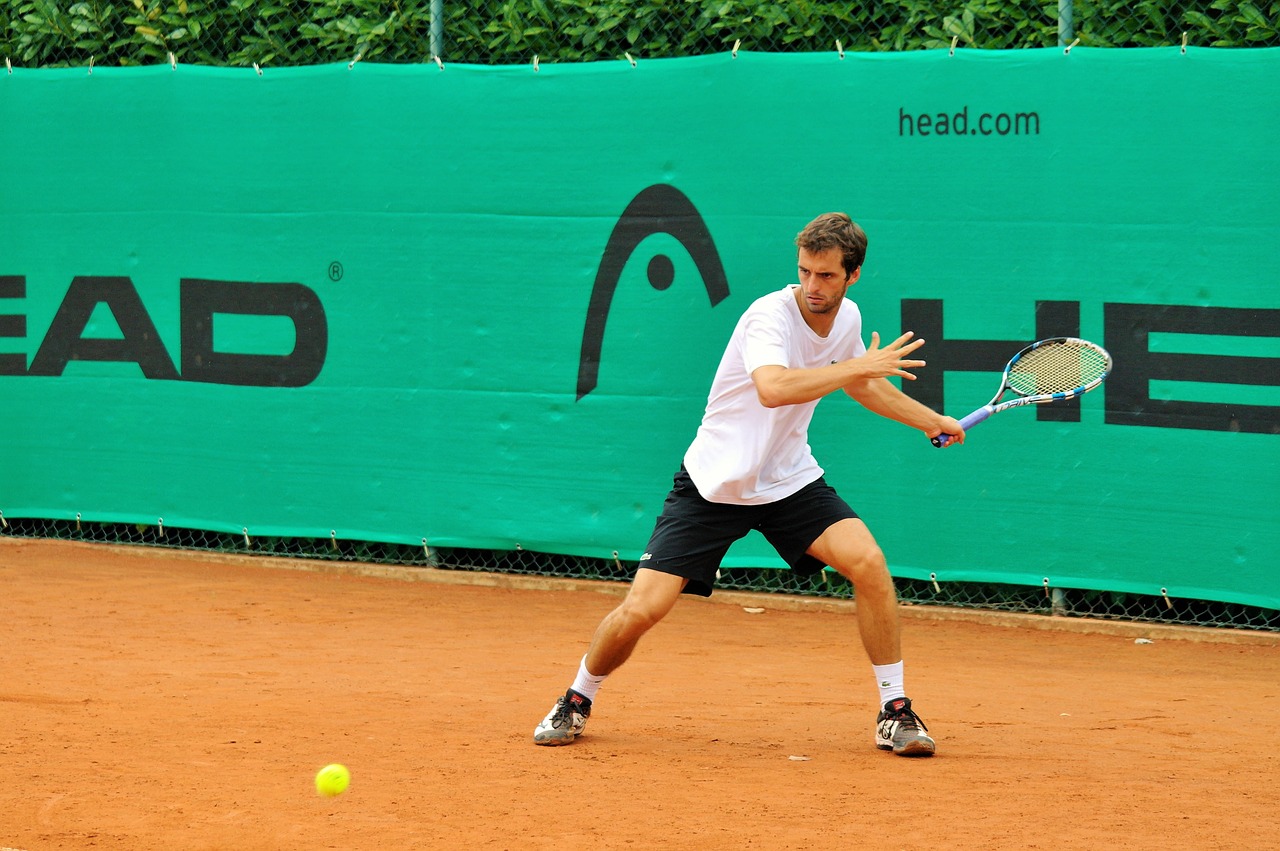 Man playing tennis on court