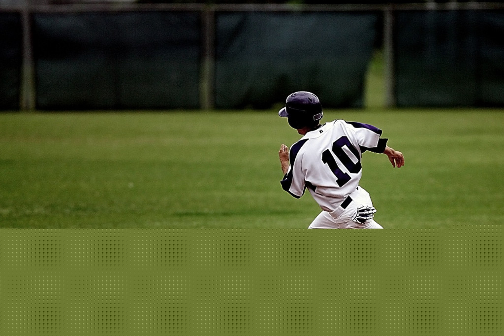 Baseball player running around diamond during game