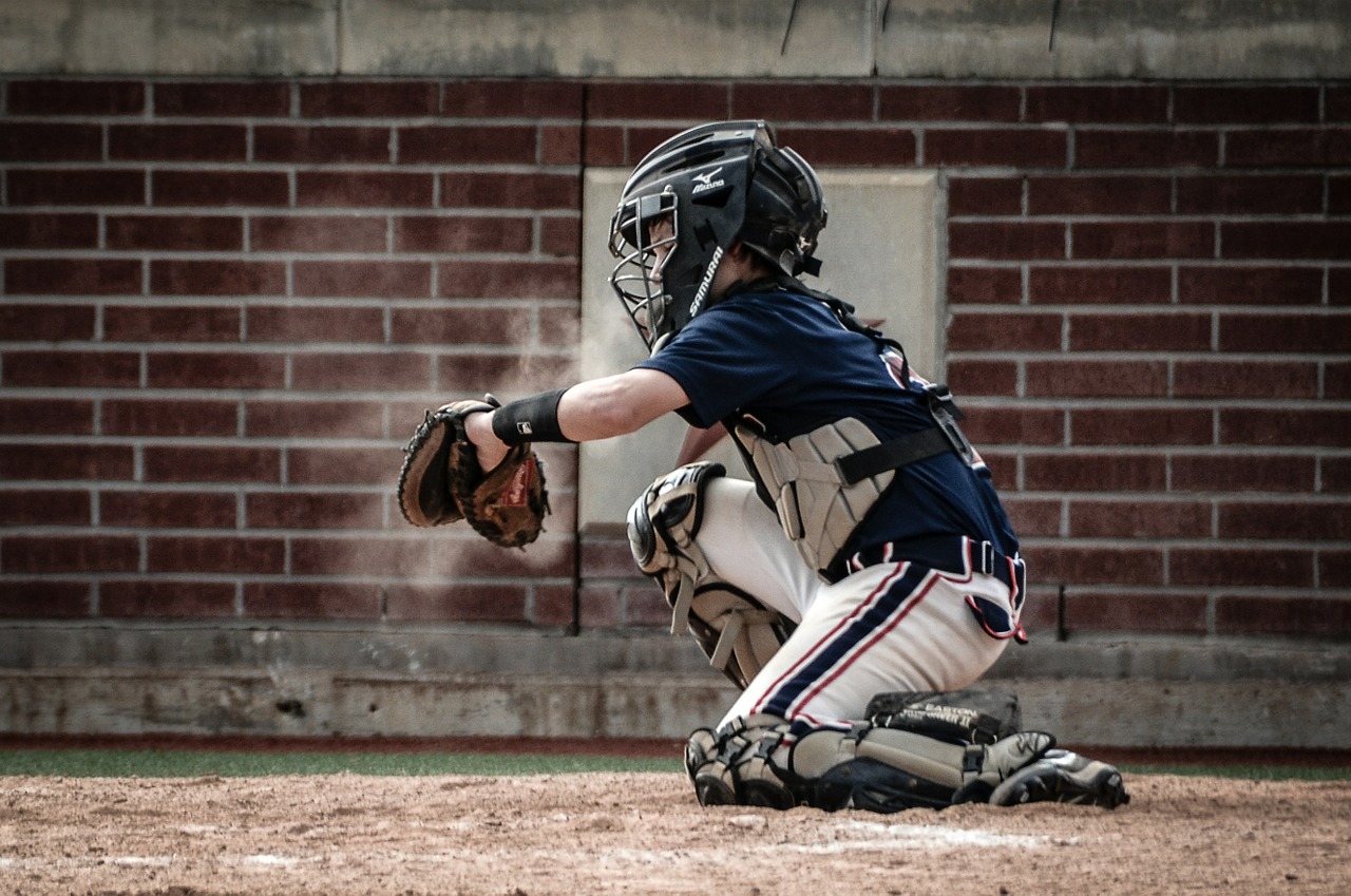 Baseball player catching ball during game