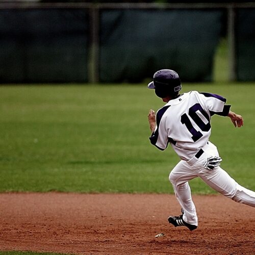 Baseball player running around diamond during game