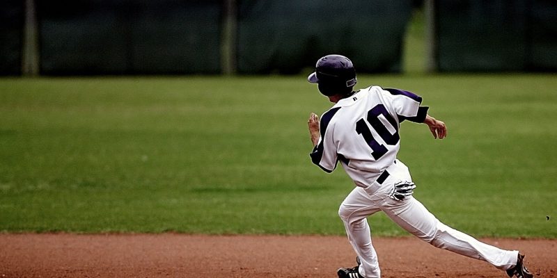 Baseball player running around diamond during game