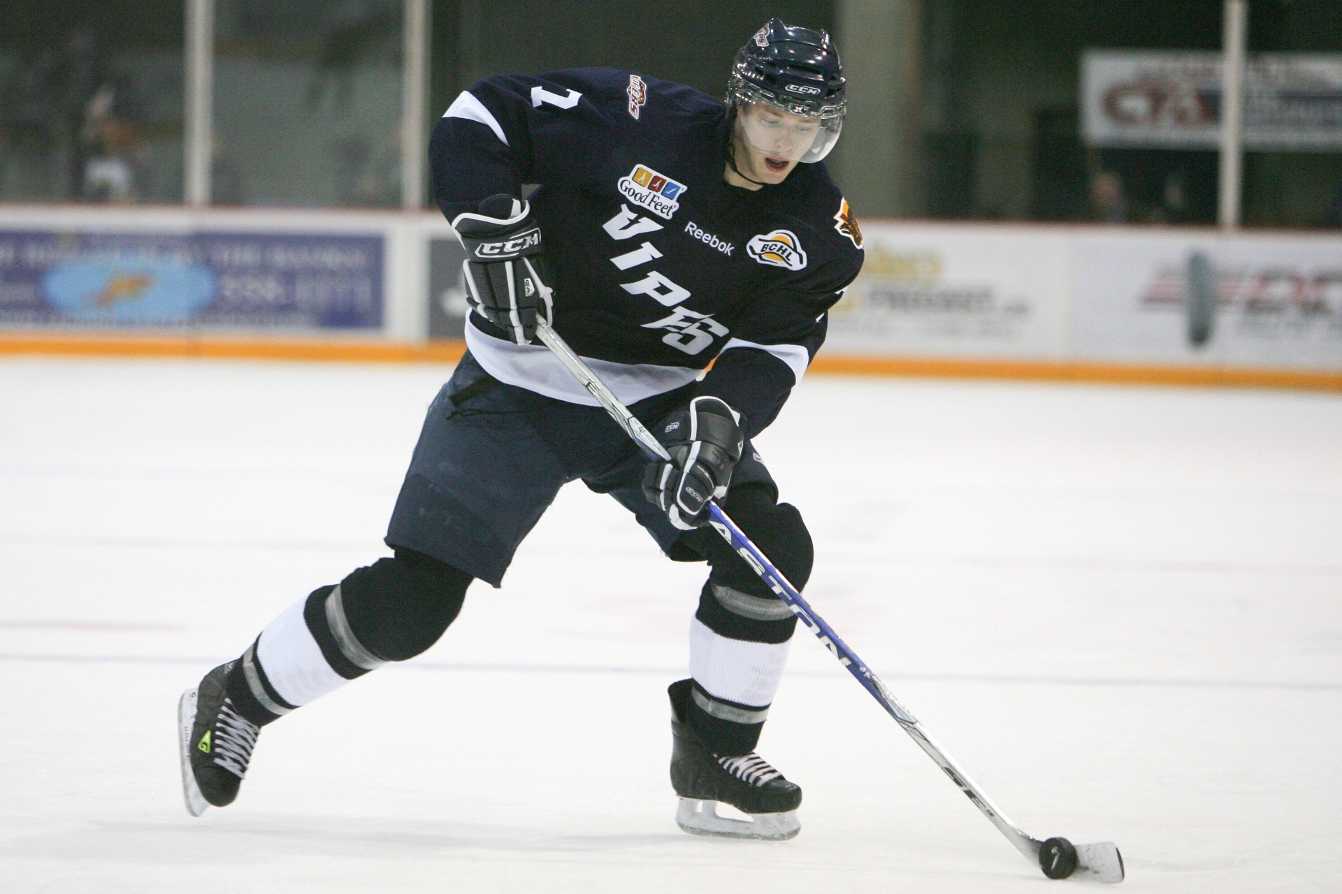Hockey player handling puck with stick during game