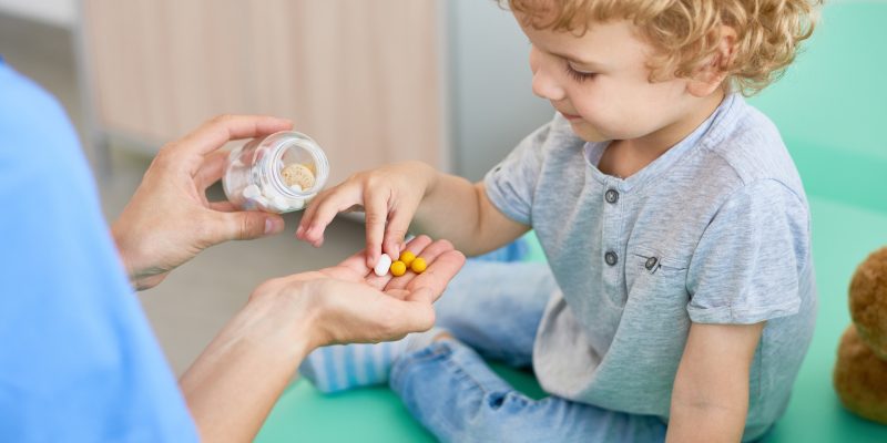Kid taking a supplement