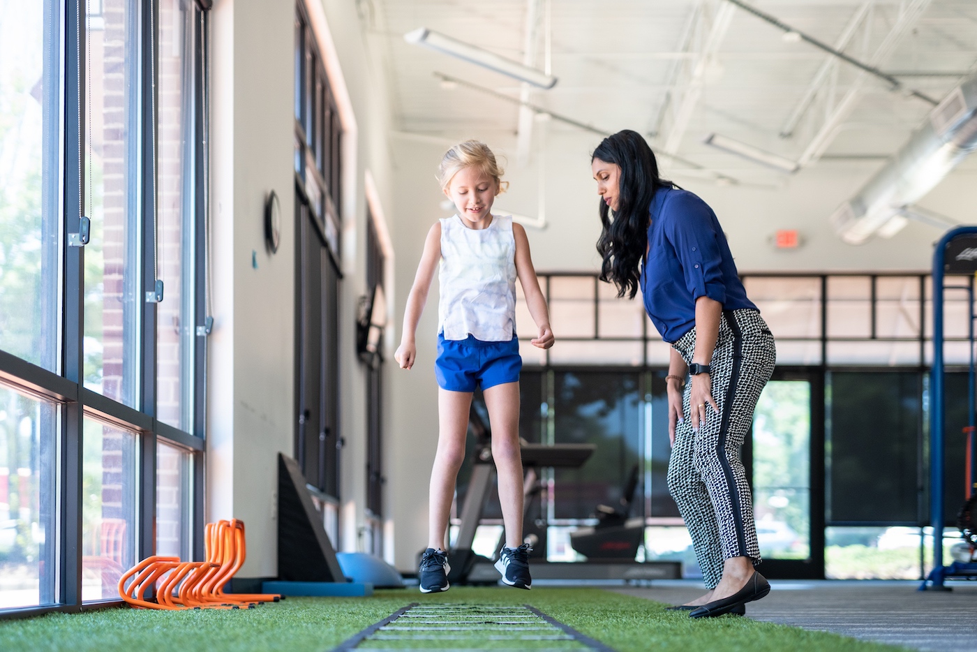 Physiotherapist working with child who has suffered from shin splints